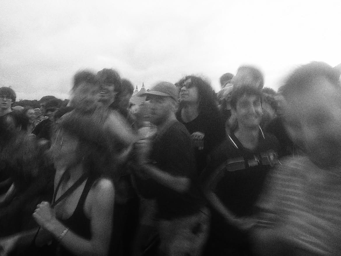 A blurred crowd moving at the front of a stage